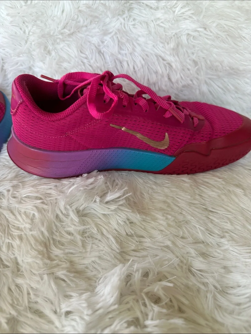 Nike Women's Bold Pink Athletic Court Shoes with Teal Purple Gradient Accent.